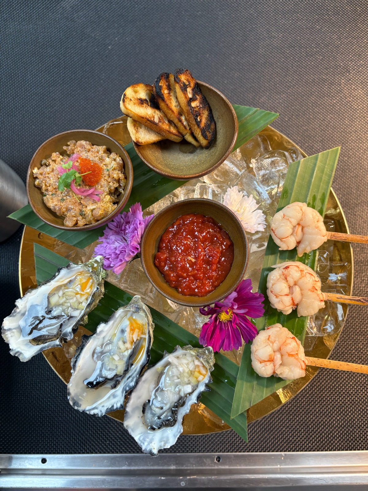 Iced seafood display with oysters, prawns and edible flowers