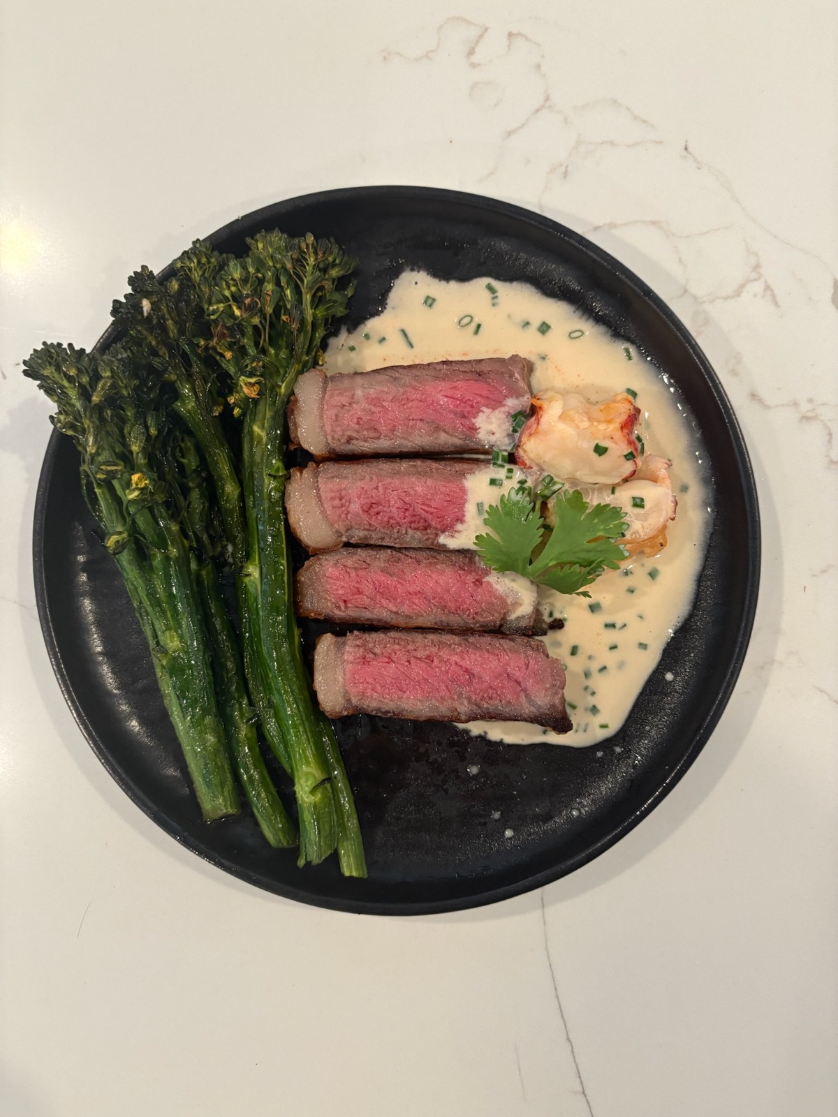 Sliced steak with lobster and broccolini