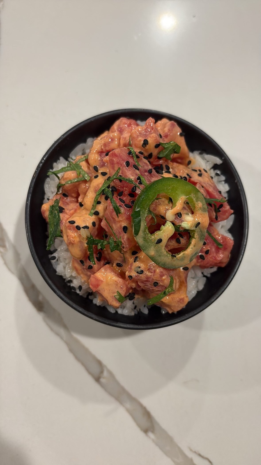 Spicy tuna over crisped rice with jalapeno