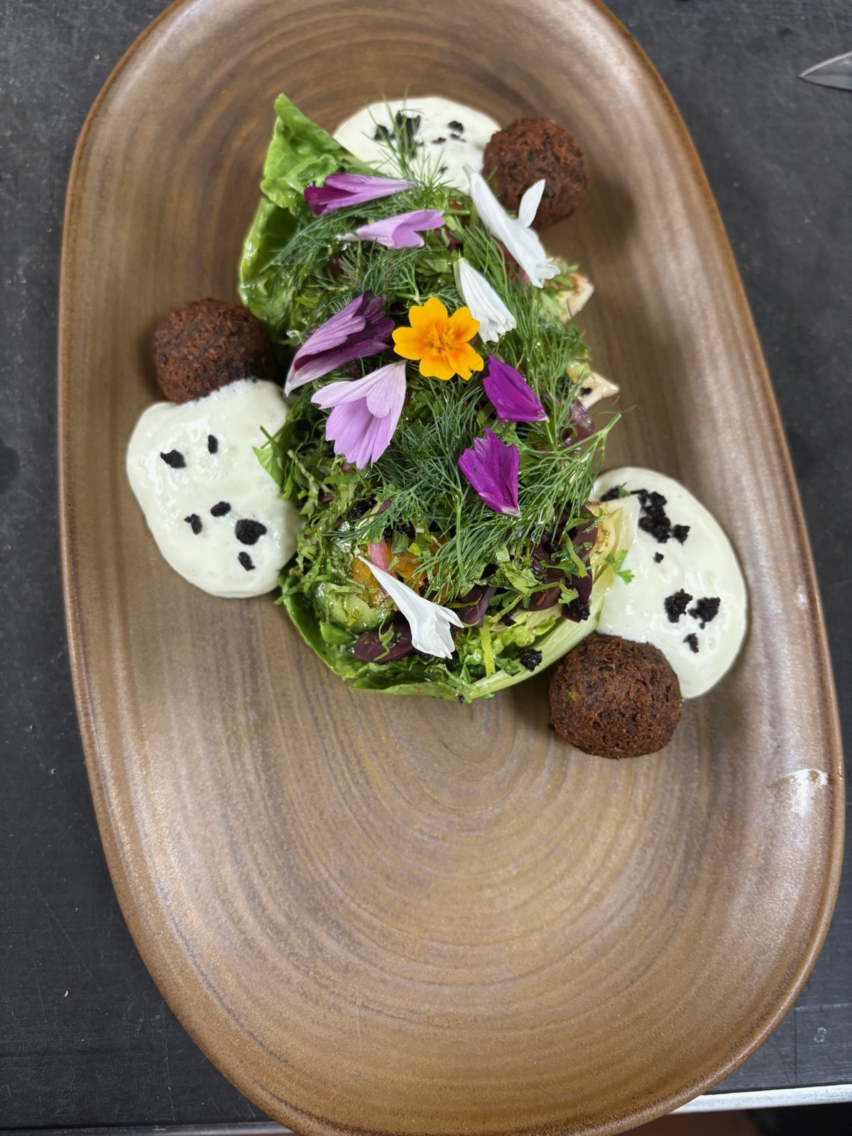 Falafel and greens with edible flowers and herbed yogurt