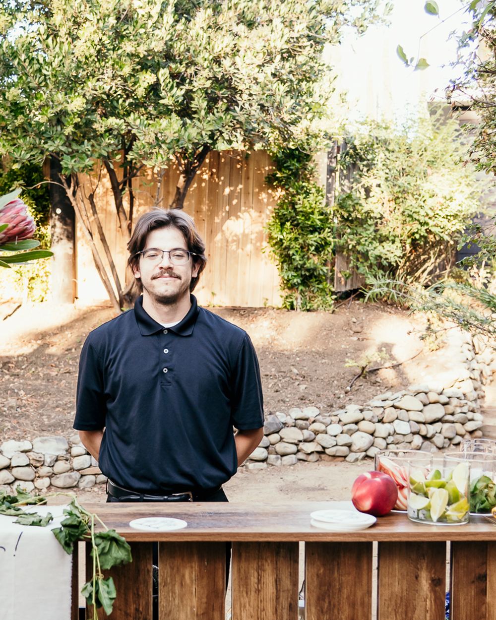 Michael Sanchez, founder and chef of S27, behind his bar setup at an outdoor event